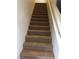Carpeted stairs leading to the upper level with a white handrail at 8111 Switchback Run St, Las Vegas, NV 89166
