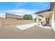 View of the backyard with a large concrete pad and an outdoor patio with seating at 8220 Redbud Vine St, North Las Vegas, NV 89085