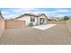 Fenced backyard with a concrete pad, patio, and well-maintained landscaping at 8220 Redbud Vine St, North Las Vegas, NV 89085