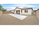 Landscaped backyard featuring a concrete pad and covered patio at 8220 Redbud Vine St, North Las Vegas, NV 89085