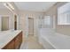 Bathroom with double sinks, a bathtub and a separate shower at 8220 Redbud Vine St, North Las Vegas, NV 89085