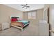 Well-lit bedroom features a double bed, side table and a dresser at 8220 Redbud Vine St, North Las Vegas, NV 89085
