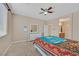 Bright bedroom with a double bed, dresser, mirror and ceiling fan at 8220 Redbud Vine St, North Las Vegas, NV 89085