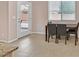 Bright dining area with large windows, neutral walls, tile flooring and easy access to the backyard through the sliding door at 8220 Redbud Vine St, North Las Vegas, NV 89085