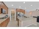 Gourmet kitchen features granite countertops, stainless steel appliances, walk-in pantry and seamless flow into the living area at 8220 Redbud Vine St, North Las Vegas, NV 89085