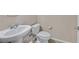 Cozy powder room with a pedestal sink and toilet at 8220 Redbud Vine St, North Las Vegas, NV 89085