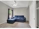 Bedroom with a blue sofa bed, ceiling fan, neutral walls, and closet at 840 Picotte St # 101, Las Vegas, NV 89144