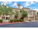 Inviting condo building featuring a well-maintained facade, attached garages, and colorful manicured landscaping at 840 Picotte St # 101, Las Vegas, NV 89144