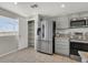 Bright kitchen with stainless steel appliances, tile flooring, ample storage, and a view from the window at 840 Picotte St # 101, Las Vegas, NV 89144