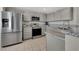 Modern kitchen featuring stainless steel appliances, granite countertops, and ample cabinet space for storage at 840 Picotte St # 101, Las Vegas, NV 89144