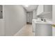 Well-lit laundry room featuring a sink, washer, dryer, and storage cabinets at 840 Picotte St # 101, Las Vegas, NV 89144