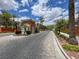 Paved street leading to guardhouse with lush landscaping and palm trees at 840 Picotte St # 101, Las Vegas, NV 89144