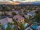 Aerial view of a community featuring a golf course, mountain views, and several homes with in-ground pools at 8808 Rozetta Ct, Las Vegas, NV 89134