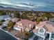 Expansive aerial view of a residential community with lush landscaping and mountain views at 8808 Rozetta Ct, Las Vegas, NV 89134