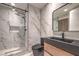 Sleek bathroom featuring a modern vanity, toilet, and a luxurious walk-in shower with marble accents at 8808 Rozetta Ct, Las Vegas, NV 89134