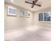 An empty bedroom featuring three windows with plantation shutters and tile floor at 8808 Rozetta Ct, Las Vegas, NV 89134
