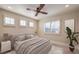 Bright bedroom featuring neutral decor, a ceiling fan, and plantation shutters at 8808 Rozetta Ct, Las Vegas, NV 89134