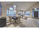 Open concept dining and living room area featuring a modern chandelier and fireplace at 8808 Rozetta Ct, Las Vegas, NV 89134