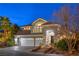 Stately two-story home with a three-car garage, manicured landscaping, and inviting front entrance at 8808 Rozetta Ct, Las Vegas, NV 89134