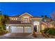 Stunning two-story home with a three-car garage, tile roof, and lush landscaping at 8808 Rozetta Ct, Las Vegas, NV 89134