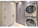 Laundry room with modern gray cabinets and front loading washer and dryer at 8808 Rozetta Ct, Las Vegas, NV 89134