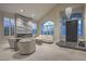 Elegant living room with a modern fireplace, tiled floor, and large front door at 8808 Rozetta Ct, Las Vegas, NV 89134
