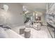 Bright open-concept living room featuring a chandelier, fireplace, and staircase at 8808 Rozetta Ct, Las Vegas, NV 89134