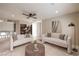 Bright living room with modern sofas, a ceiling fan, and stylish decor, creating a welcoming space at 8808 Rozetta Ct, Las Vegas, NV 89134