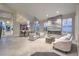 Open-concept living room with modern fireplace, large windows, and vaulted ceilings at 8808 Rozetta Ct, Las Vegas, NV 89134