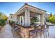 Outdoor kitchen with bar seating, grill, sink, and covered patio at 8808 Rozetta Ct, Las Vegas, NV 89134