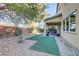 Low maintenance backyard with artificial turf, rock landscaping, and patio at 8992 Sparkling River Ct, Las Vegas, NV 89178