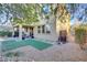 This backyard features a small, covered patio, rock landscaping and a patch of artificial turf at 8992 Sparkling River Ct, Las Vegas, NV 89178