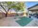 Low maintenance backyard with rock landscaping, turf, and covered patio at 8992 Sparkling River Ct, Las Vegas, NV 89178