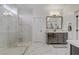 Modern bathroom with a large glass shower, double vanity, and marble floors at 8992 Sparkling River Ct, Las Vegas, NV 89178