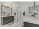 Bright bathroom featuring dual vanities, framed mirrors, and modern fixtures at 8992 Sparkling River Ct, Las Vegas, NV 89178
