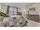 Bedroom with a large bed, neutral tones, and natural light, creating a serene space at 8992 Sparkling River Ct, Las Vegas, NV 89178