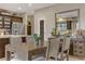 Elegant dining room with a modern table set, a large mirror, and views into the kitchen at 8992 Sparkling River Ct, Las Vegas, NV 89178