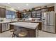 Modern kitchen with stainless steel appliances, a central island, and classic white countertops at 8992 Sparkling River Ct, Las Vegas, NV 89178