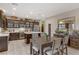 Elegant eat-in kitchen with dark cabinets, stainless appliances, and tile flooring at 8992 Sparkling River Ct, Las Vegas, NV 89178