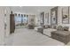 Spacious living room with a large sectional sofa, window seating, and neutral decor at 8992 Sparkling River Ct, Las Vegas, NV 89178