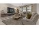 Comfortable living room featuring modern decor, neutral color palette and wall-mounted TV at 8992 Sparkling River Ct, Las Vegas, NV 89178