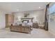 Bright main bedroom features wood furnishings, neutral paint, carpet, and large windows at 8992 Sparkling River Ct, Las Vegas, NV 89178