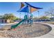 Community playground with modern play structures, slide, and shade covering surrounded by a safe playground surface at 8992 Sparkling River Ct, Las Vegas, NV 89178