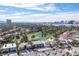Overhead view of the community with a golf course and pond; Las Vegas cityscape visible on a bright day at 915 Vegas Valley Dr # 4, Las Vegas, NV 89109