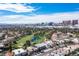 Scenic aerial view featuring a lush golf course, community homes, and the vibrant Las Vegas cityscape at 915 Vegas Valley Dr # 4, Las Vegas, NV 89109
