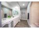 Spacious bathroom featuring double sinks, shower, bathtub, and sleek flooring at 915 Vegas Valley Dr # 4, Las Vegas, NV 89109