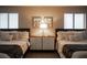Well-lit bedroom featuring two beds, a center nightstand, and neutral decor at 915 Vegas Valley Dr # 4, Las Vegas, NV 89109