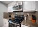 Bright kitchen featuring stainless steel microwave and range with granite countertops at 915 Vegas Valley Dr # 4, Las Vegas, NV 89109