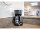 Close up of a coffee maker in the kitchen with a view to the main living space at 915 Vegas Valley Dr # 4, Las Vegas, NV 89109