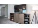 Living room features a large television atop a wood cabinet with a lamp and open door at 915 Vegas Valley Dr # 4, Las Vegas, NV 89109